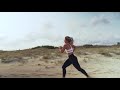 young blonde woman running on the beach