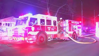 Woman hospitalized after overnight fire where downed powerlines held firefighters back