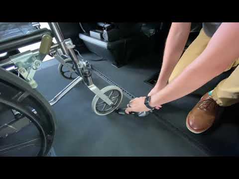 When securing a wheelchair using the 4 down 3 around method What do you secure first?