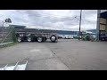 stretched 2022 389 peterbilt backing into tight seattle shop with front overhanging steel beams