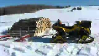 atv in snow log skidding wood