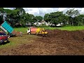 Bulldozer Komatsu D21P Pushing Isuzu Elf Dump Truck Stuck In Mud