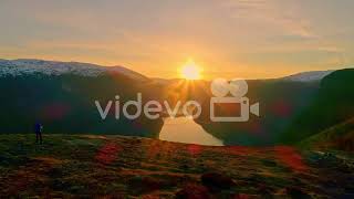 Isolated man contemplating amazing landscape of fjord at sunset, Norway