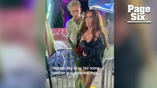 Megan Fox gets slammed into barricade as man tries to punch Machine Gun Kelly at fair