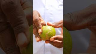 Peeling and tasting tangerine : fresh from tree.