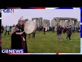 Record crowds gathered at the Stonehenge in Wiltshire to celebrate the winter solstice