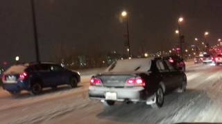 Genius driving on bare rim in Denver 1/4/2017 snowstorm