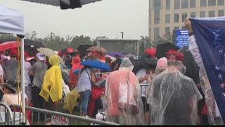 President Trump rally goers wait through intense weather to get through the doors