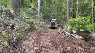 Clearing out a Dirt Road in the Woods with a Cat 289D Compact Track Loader