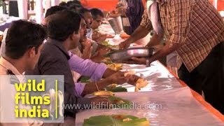 Volunteers serving traditional Kerala food during Onam