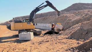 Heavy Machinery Moves Cement Blocks | Retaining Wall Construction Project