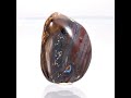 intricately patterned boulder opal cabochon