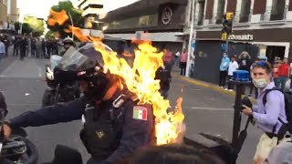 Police officer set on fire during protests in Mexico