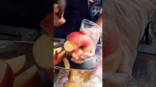 Neatly cutting apples at a street vendor