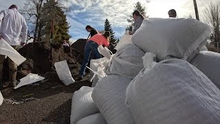 Albion residents and volunteers fill sandbags in anticipation of potential flooding