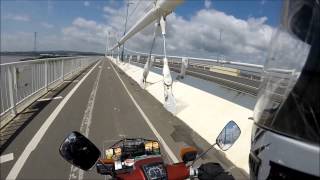 Riding across the Severn Bridge on a Honda C90