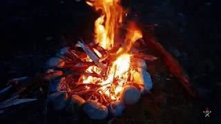 MASKED COMRADE COOKS DINNER IN THE WOODS