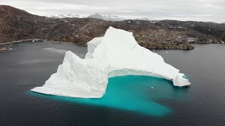 GIANT ICEBERG COLLAPSES,  SWAMPS LOCAL FISHING VILLAGE. BOATS SEEN IN RAW FOOTAGE.