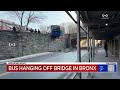 mta bus dangles from elevated road in the bronx amid morning commute