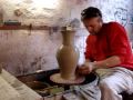 Throwing a big clay pottery vase on the wheel