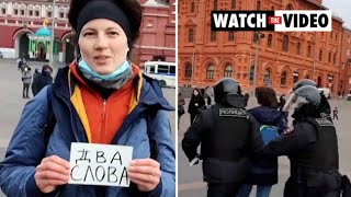 Woman holding sign in Moscow dragged away by security forces