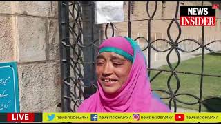 A women crying outside Jamia Masjid gate for not allowing prayers inside Mosques in Valley