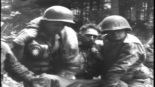 US medic gives first aid to a wounded soldier near Wegscheid Germany. HD Stock Footage