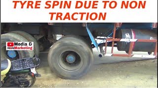 Rear 8 wheels spinning without traction, damaged tyre in state of bursting. Tandem axle spinning