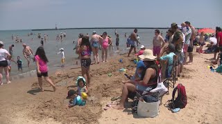 Beachgoers take advantage of summer weather on Father's Day