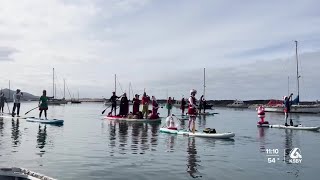 Carolers take to the water in Morro Bay during holiday paddleboard event