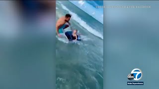 Boy escapes close encounter with shark thanks to police officer