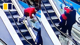 Quick-thinking man saves woman from tumbling down escalator