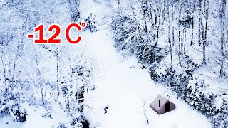 Hot tent, in the middle of an isolated snowy forest.