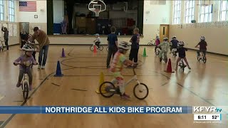 Northridge fourth and fifth graders helping teach the kindergartners learn to ride bikes