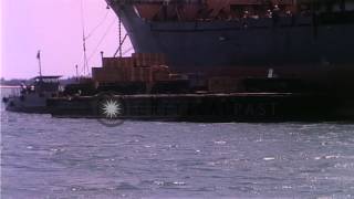 Offload of supplies onto barge from merchant ship at harbor in Da Nang. HD Stock Footage