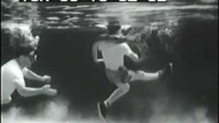 1940s 2 men wrestle giant snake underwater