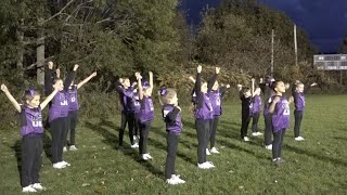 Hampden Academy youth cheerleaders rooting on the Broncos