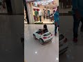 Kid driving car in a mall