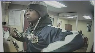 Video shows bank robber flashing gun at teller