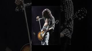 Jimmy Page converses with his guitar on stage