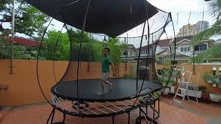 Gideon Goh shows how to do a front flip inside an oval-shaped Springfree trampoline