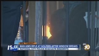 Man points rifle at golfers after wayward golf ball shatters his window