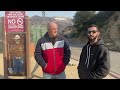 locals check the hollywood sign after seeing false reports of the iconic landmark burning