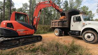 Clearing stumps for pole barn with Kubota KX080-03