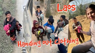 Handing out clothing in Laos, I'm very happy