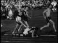 landy assists fallen rival and still wins mile race 1956