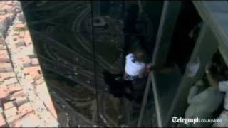 French 'Spiderman' Alain Robert slips off side off building in rare fall