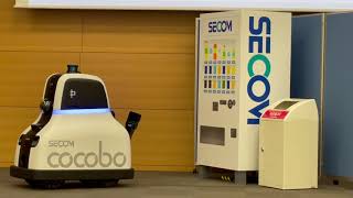 Demonstration of SECOM's security robot COCOBO checking the trash can and under the vending machine