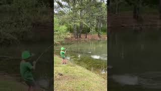 Boy Overjoyed After Catching Large Bass Out of Pond - 1128715