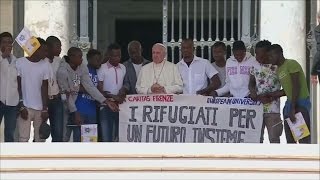 Pope Francis invites refugees on stage during general audience